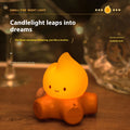 Small Fire Pile cartoon-style night lamp with yellow light on a surface.