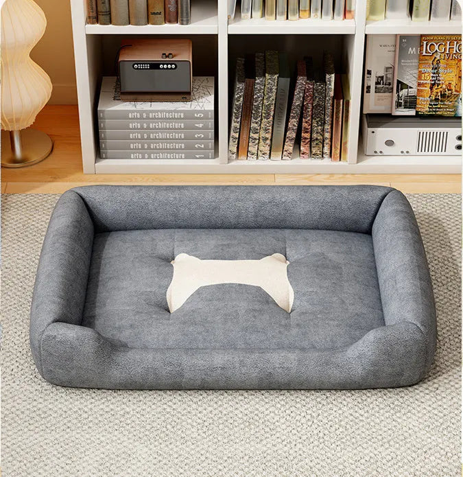 A soft, padded pet sofa mat shown in one of five colours (Black, Grey, Red, Yellow) next to a dog, illustrating its use as a furniture-protecting bed.