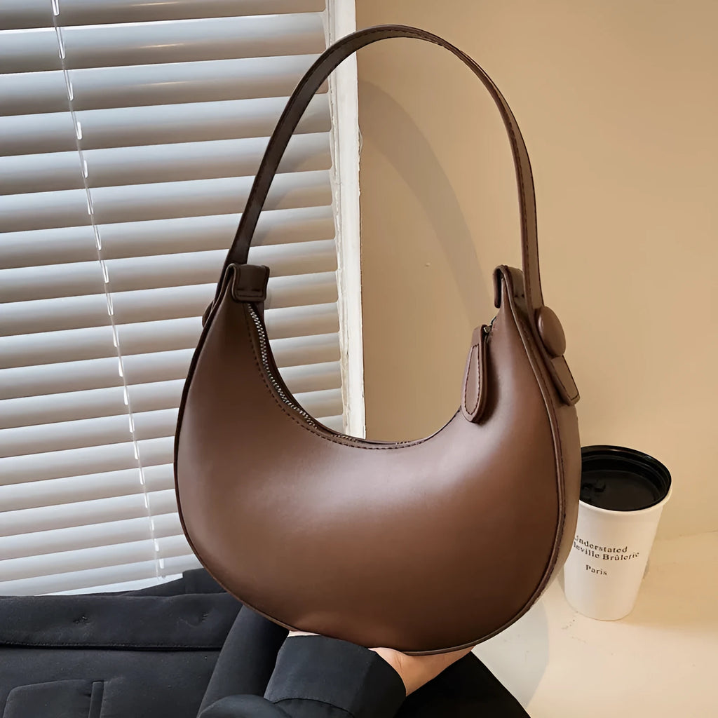 Retro dumpling-shaped women's shoulder bag in PU leather, shown in cream yellow colour.