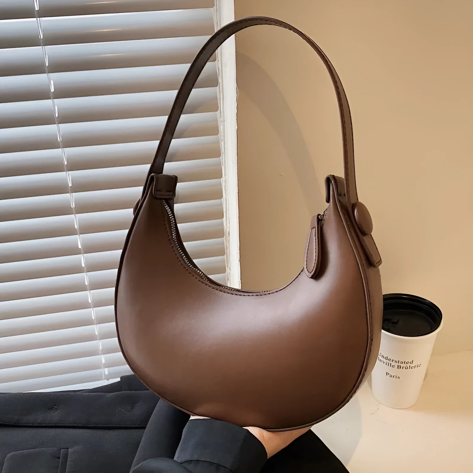 Retro dumpling-shaped women's shoulder bag in PU leather, shown in cream yellow colour.
