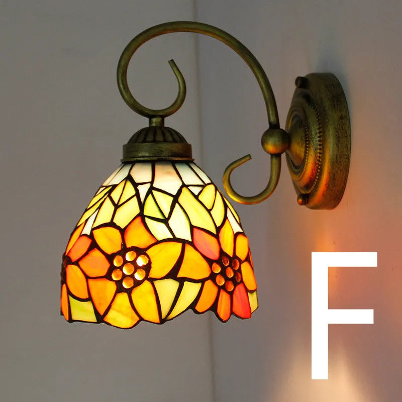 A coloured stained glass wall lamp in a simple contemporary style, mounted on a wall.