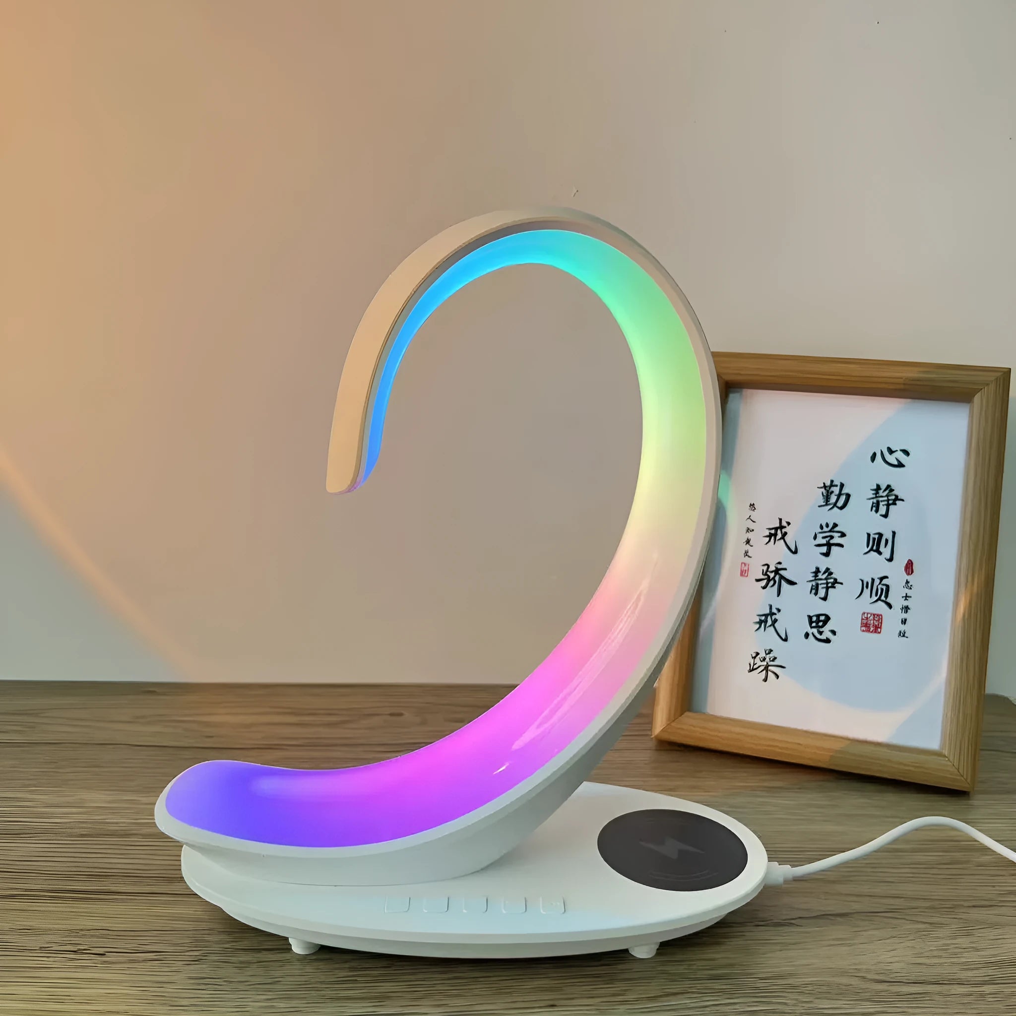 White swan-shaped desktop wireless charger with integrated Bluetooth speaker and colourful LED atmosphere light.
