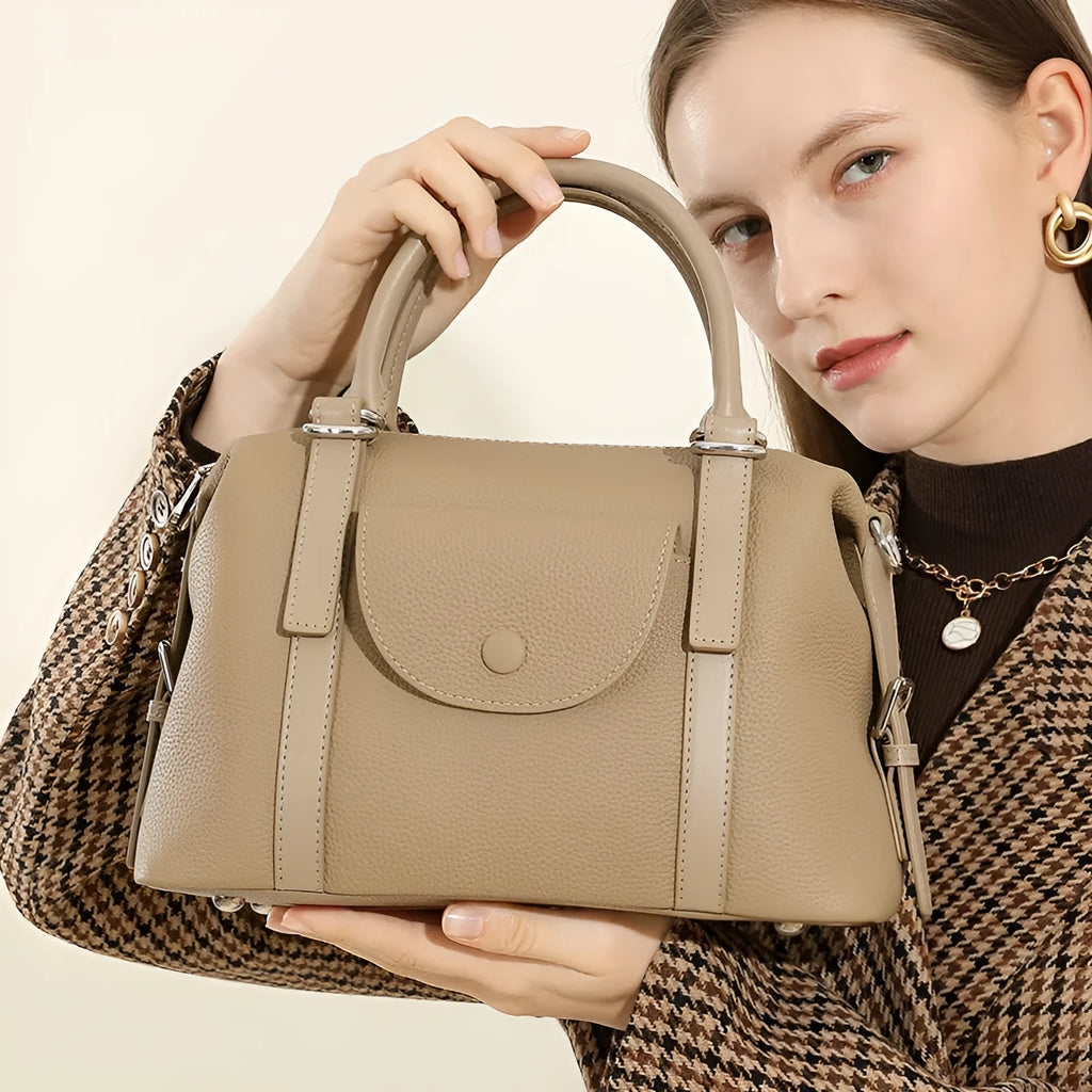 Genuine leather street trend ladies handbag with lock detail in black, brown, or elephant grey