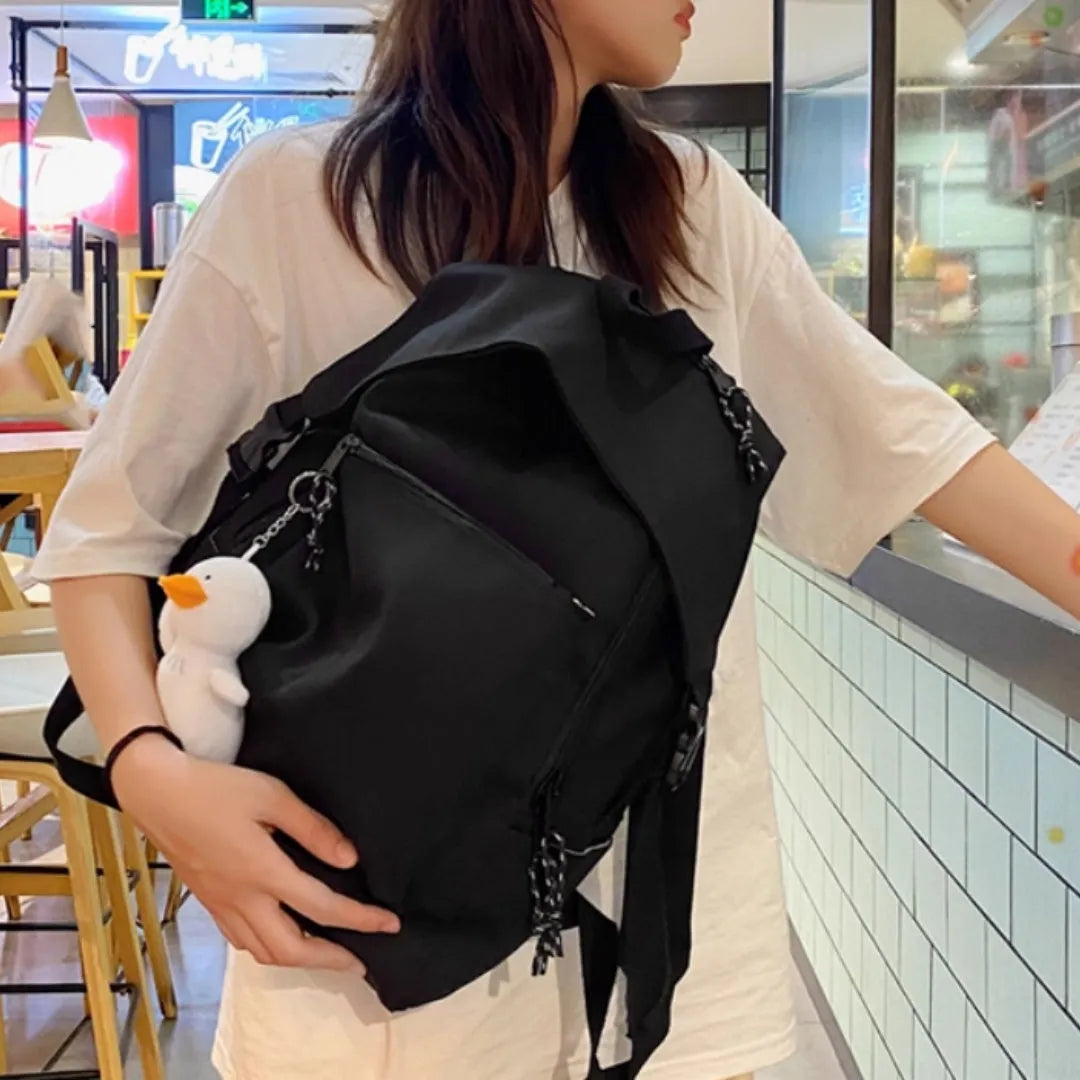 Large capacity nylon backpack in Japanese Harajuku style for female college students, vertical square shape 28x45x13cm, solid colour black, with pendant