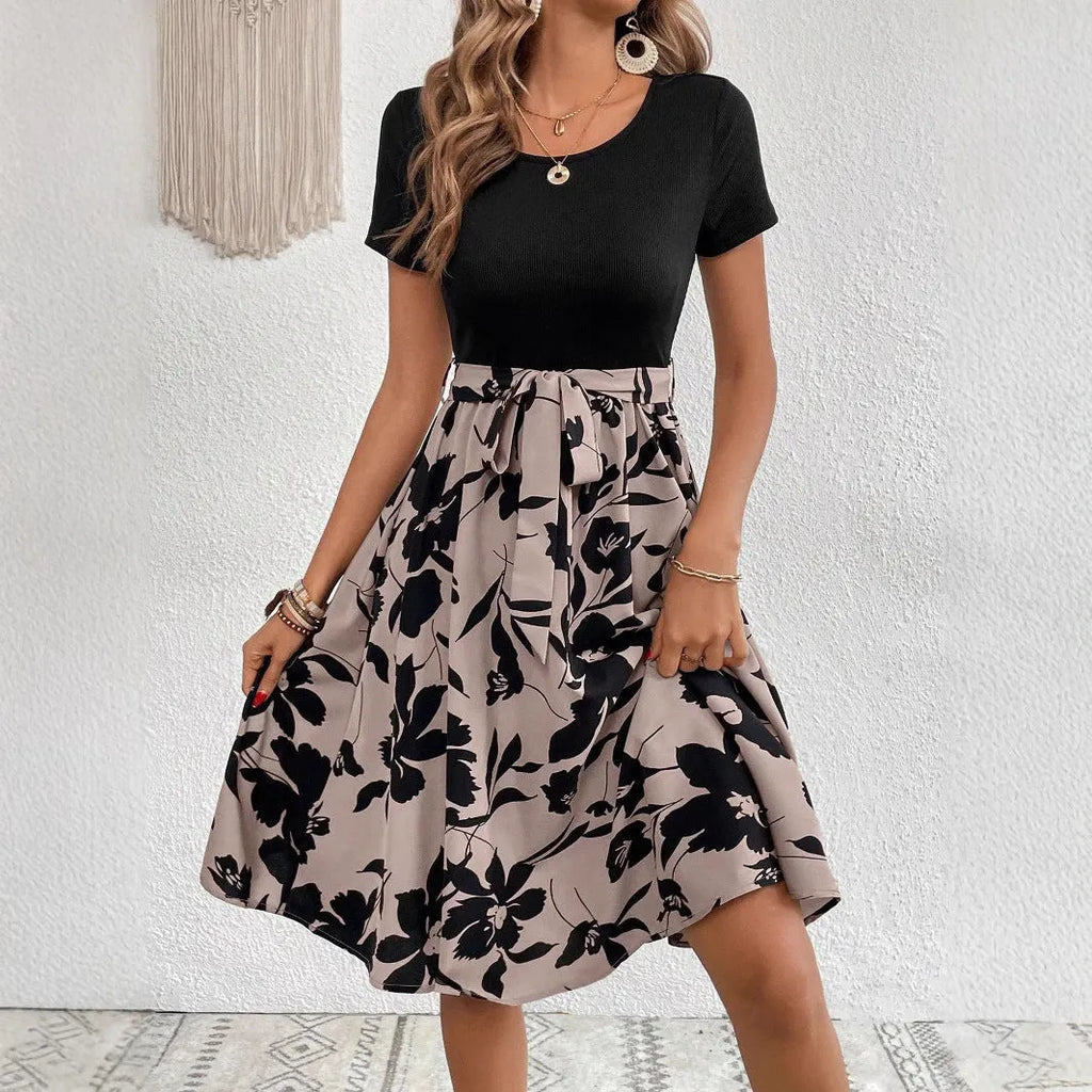Khaki A-line women's dress with lace-up detail and shoulder straps on a plant print background