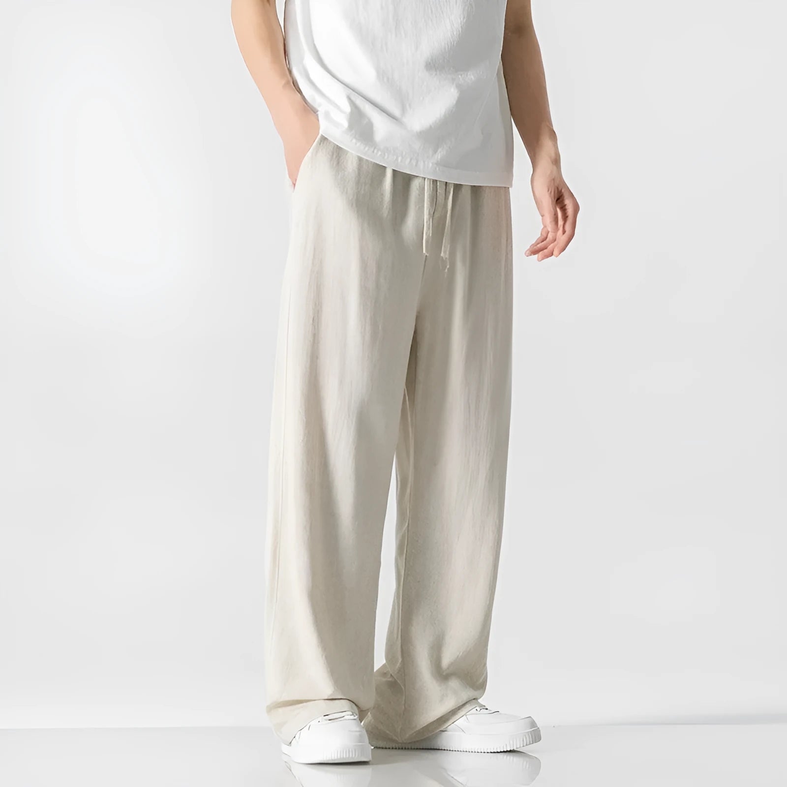 Men's beige linen-blend cropped trousers with a drawstring waist on a plain background.
