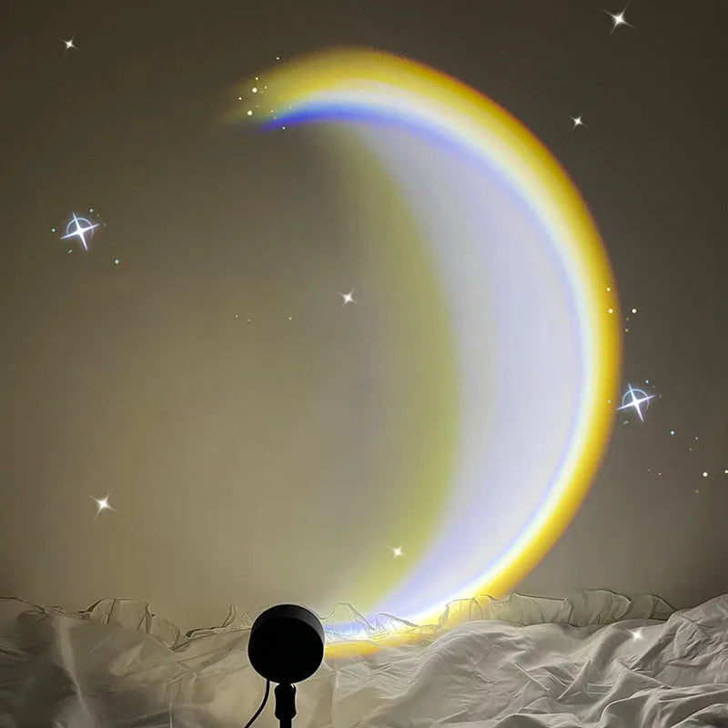 INS USB Moon Lamp LED projector on a table projecting rainbow light onto a wall.