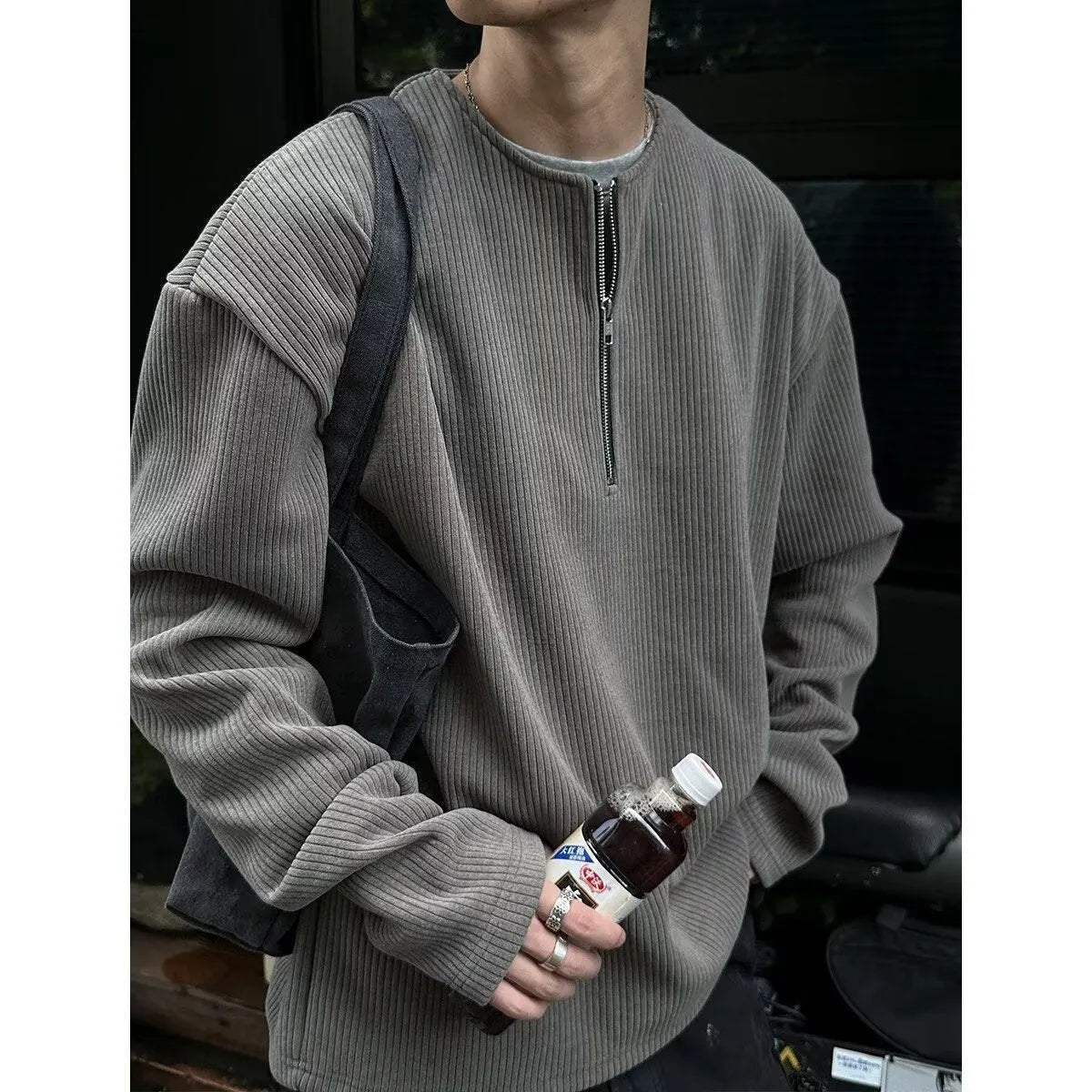 A solid colour loose pullover top for women in grey, shown as a layering piece.