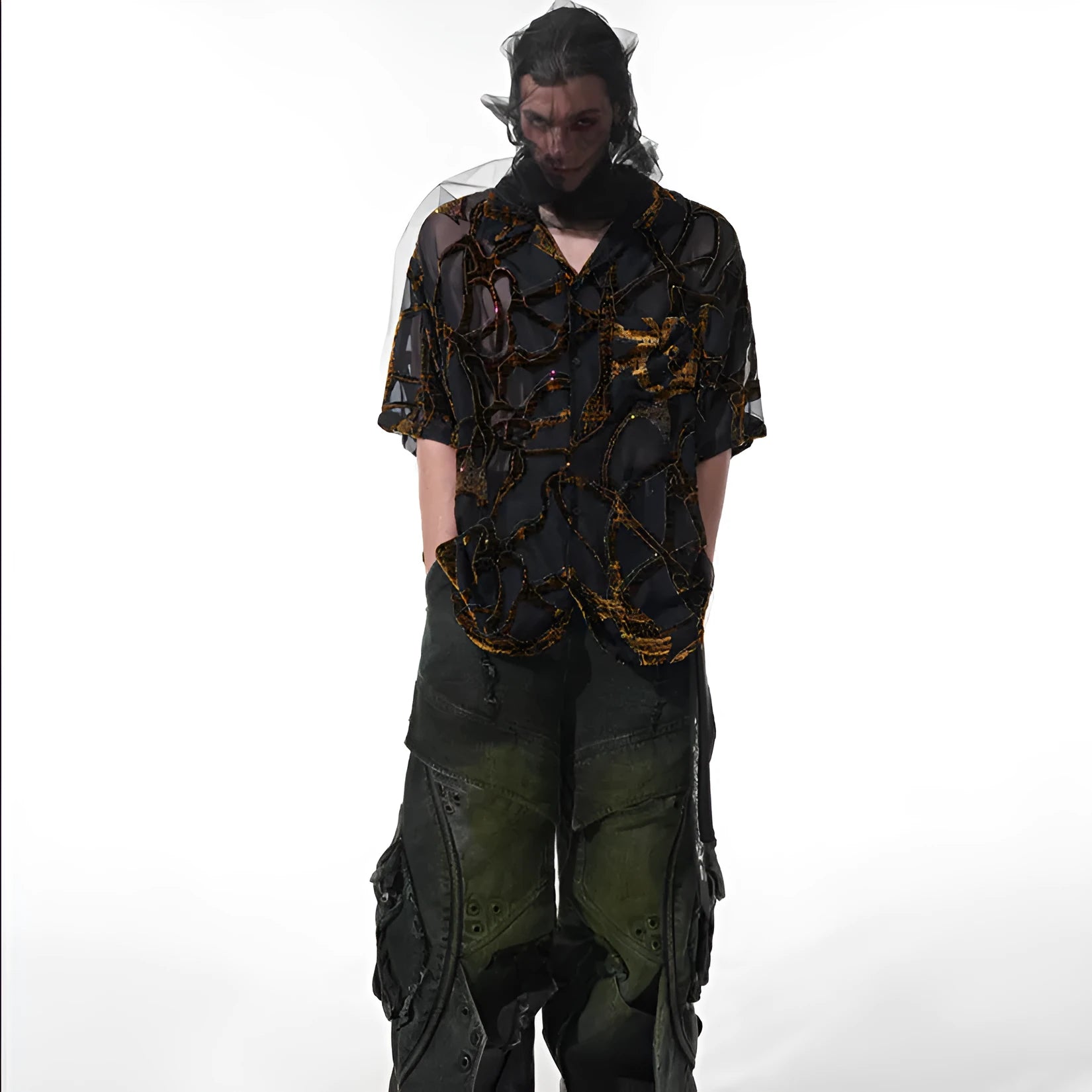 Man wearing a loose-fit black short-sleeved shirt with a translucent snake pattern print and lapel collar.