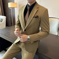 Men's slim fit dark green business suit jacket with structured shoulders on a hanger.