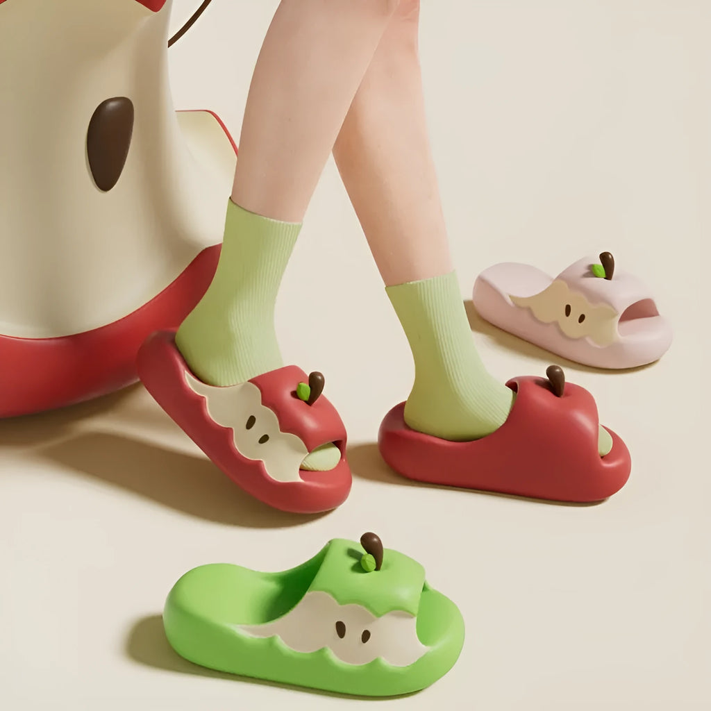 Cartoon fruit patterned EVA flip flop slippers for couples and families on a white background.
