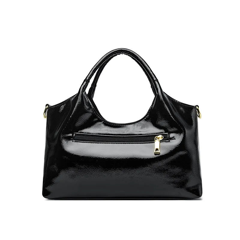Genuine leather commuter bag with glossy finish, belt decoration, and leather grain in a horizontal square shape