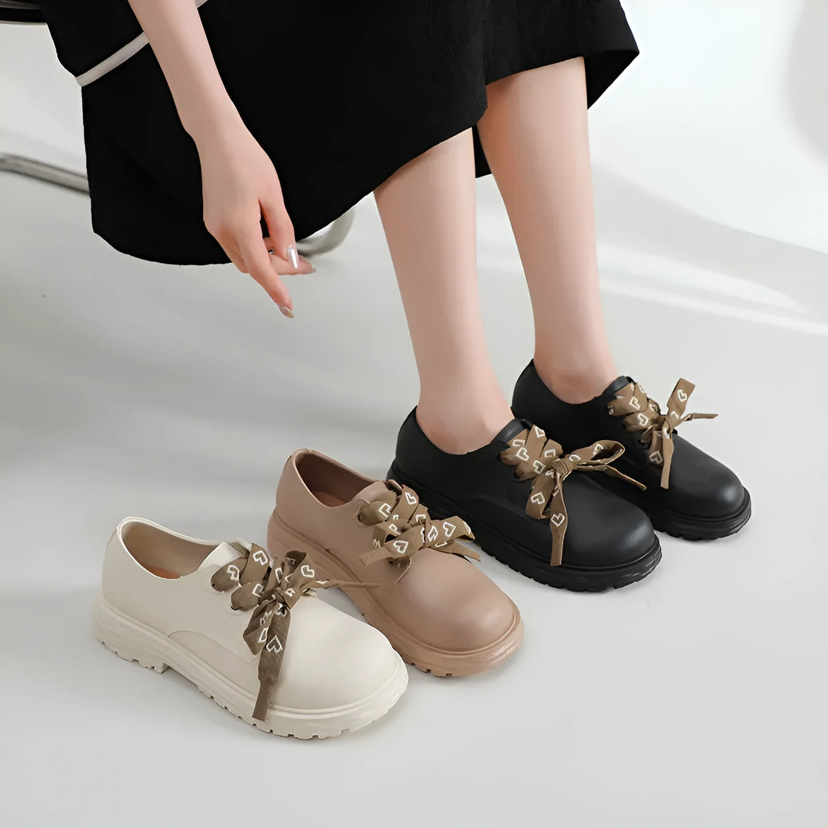 Women's mid-top rain boots with chunky low heel and round toe, available in ivory white, black, or khaki
