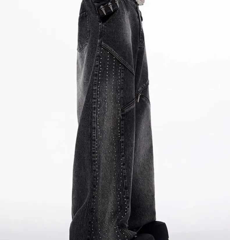 Black and grey washed wide leg cotton denim trousers and matching waistcoat set laid flat.