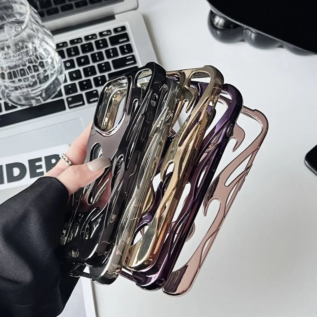 Silver electroplated iPhone case with hollow flame pattern design on a table