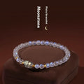 Polished moonstone bracelet with animal/Zodiac design on an adjustable cord for women.