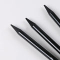 Set of six graphite and three carbonized pencils with wooden casings on a retail suction card.