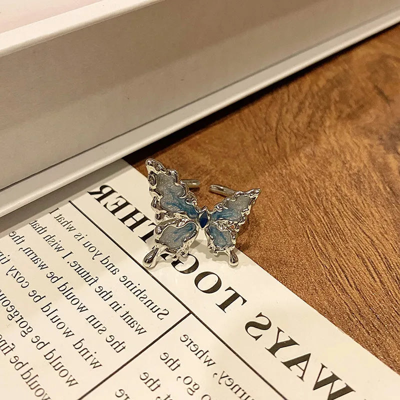 Copper butterfly women's ring with dripping oil texture and an open loop design.