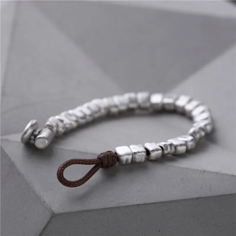Women's handmade silver bracelet with irregular square design and elastic band