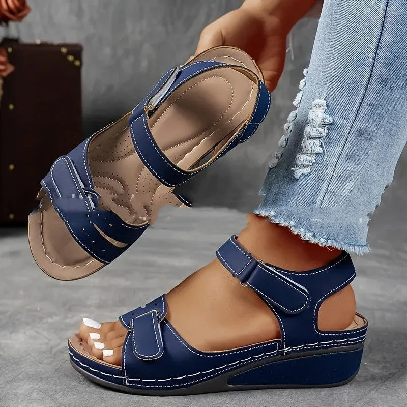 Women's beige strap sandals with thick composite sole and adjustable Velcro fastener on a white background.