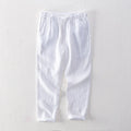 Men's straight leg linen trousers in light grey colour showing mid waist and relaxed fit