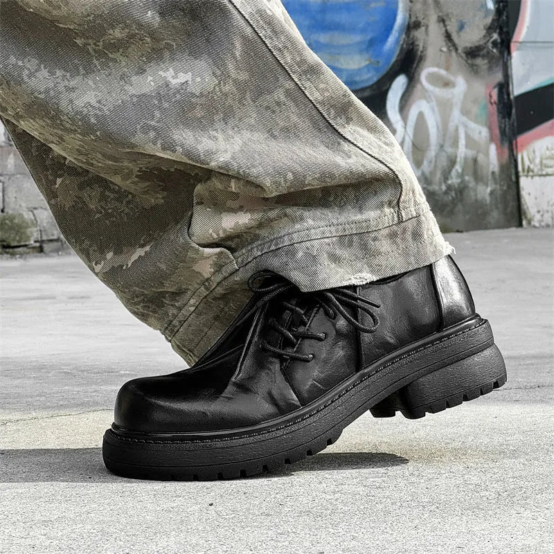 Black platform leather shoes with round toe and low top upper on a rubber sole