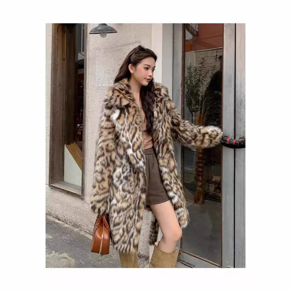 A person wearing a grey faux fur coat with a large fur collar and front pockets, in a street-fashion style.