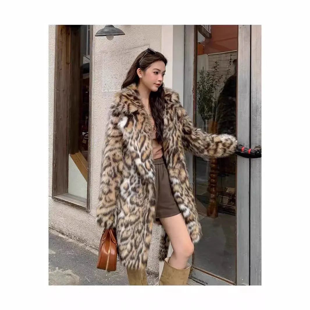 A person wearing a grey faux fur coat with a large fur collar and front pockets, in a street-fashion style.