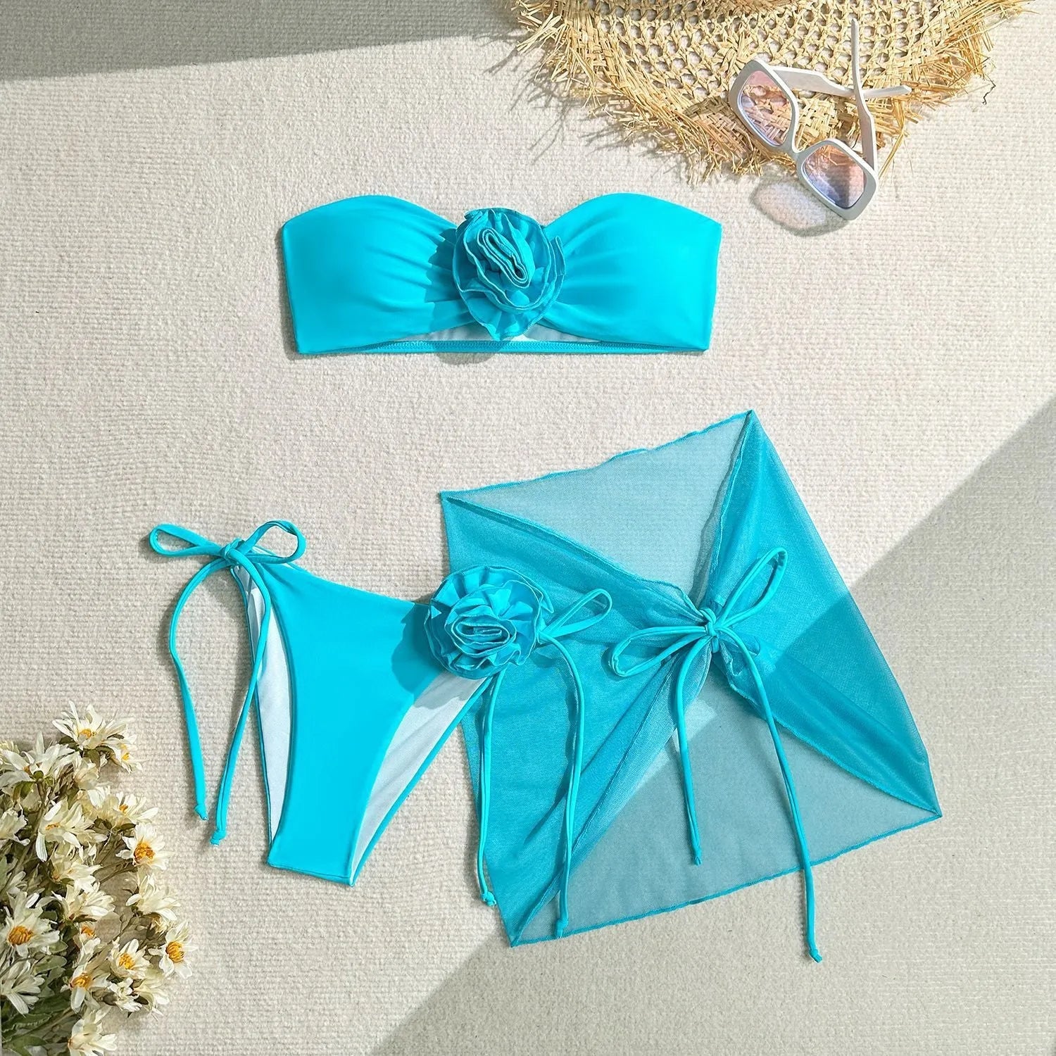 Women's pink tube top swimsuit with large 3D flower and matching skirt set on beach