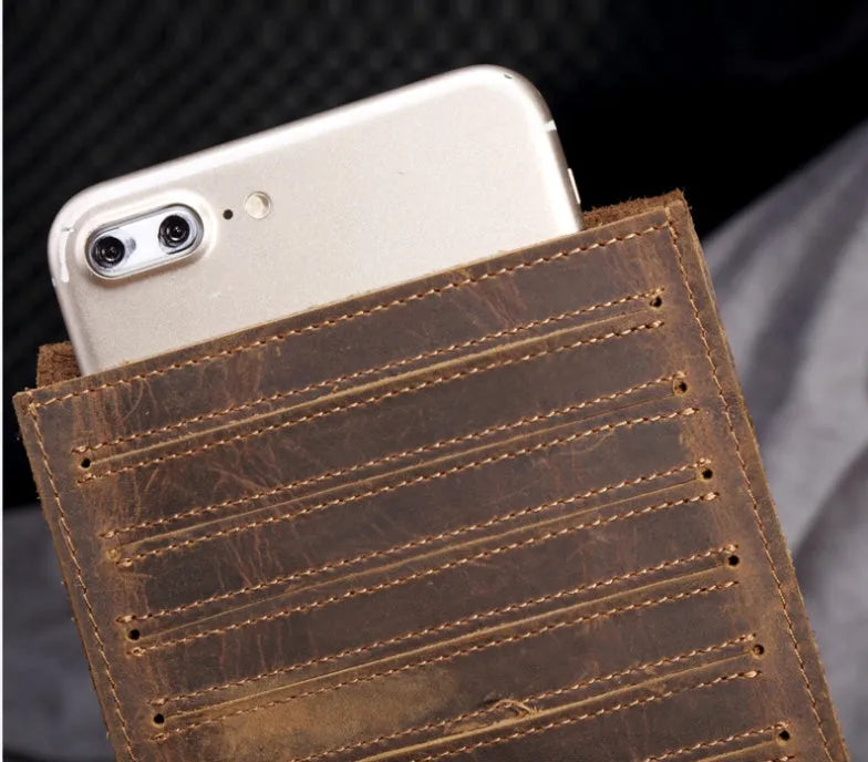 Slim brown cowhide men's wallet open to show 18 card slots and a phone compartment.