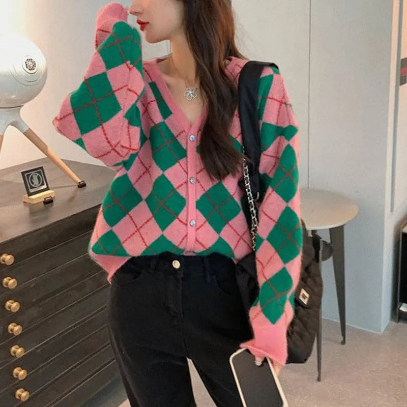 A knitted casual cardigan coat in a macaron colour, shown on a hanger with regular sleeves.