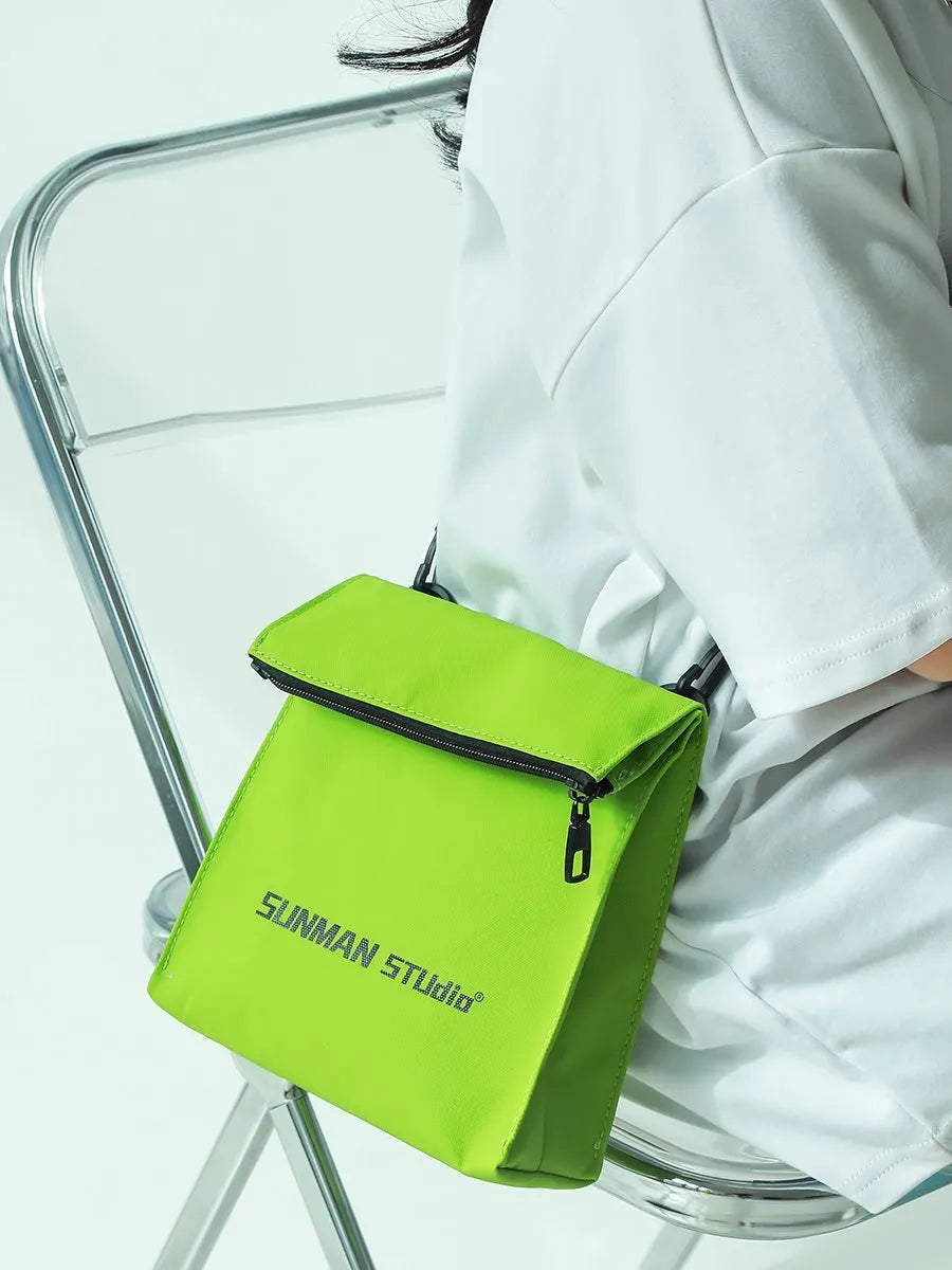 Simple messenger backpack in Oxford fabric with contrast stitching, shown in a choice of four colours.