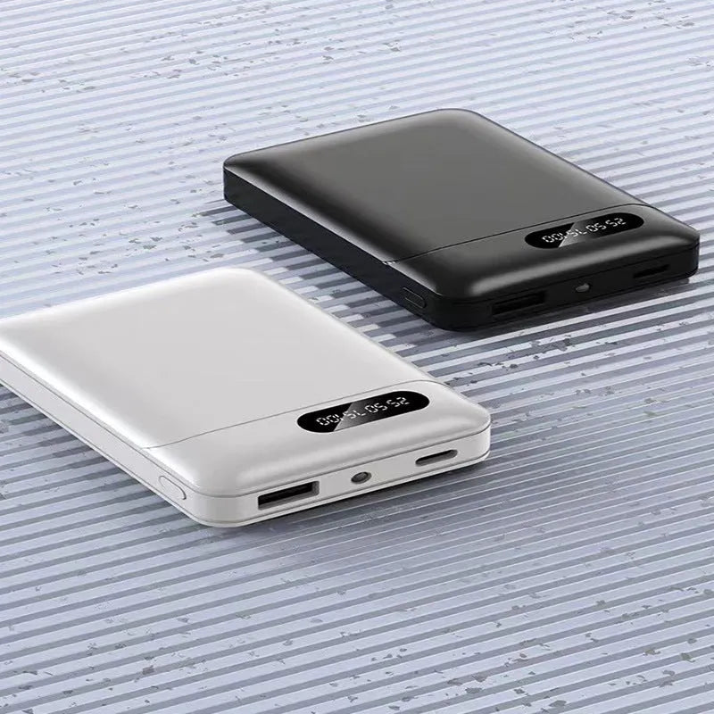 Black and white plastic power bank with dual USB ports showing 92x63x23mm dimensions