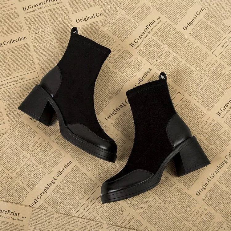 Women's black Martin boots with chunky heel and thick rubber sole, side view