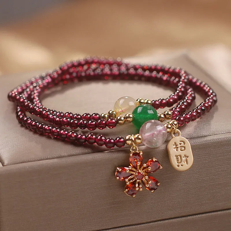 Women's natural crystal bracelet in pomegranate red cherry blossom colour with sequin accents
