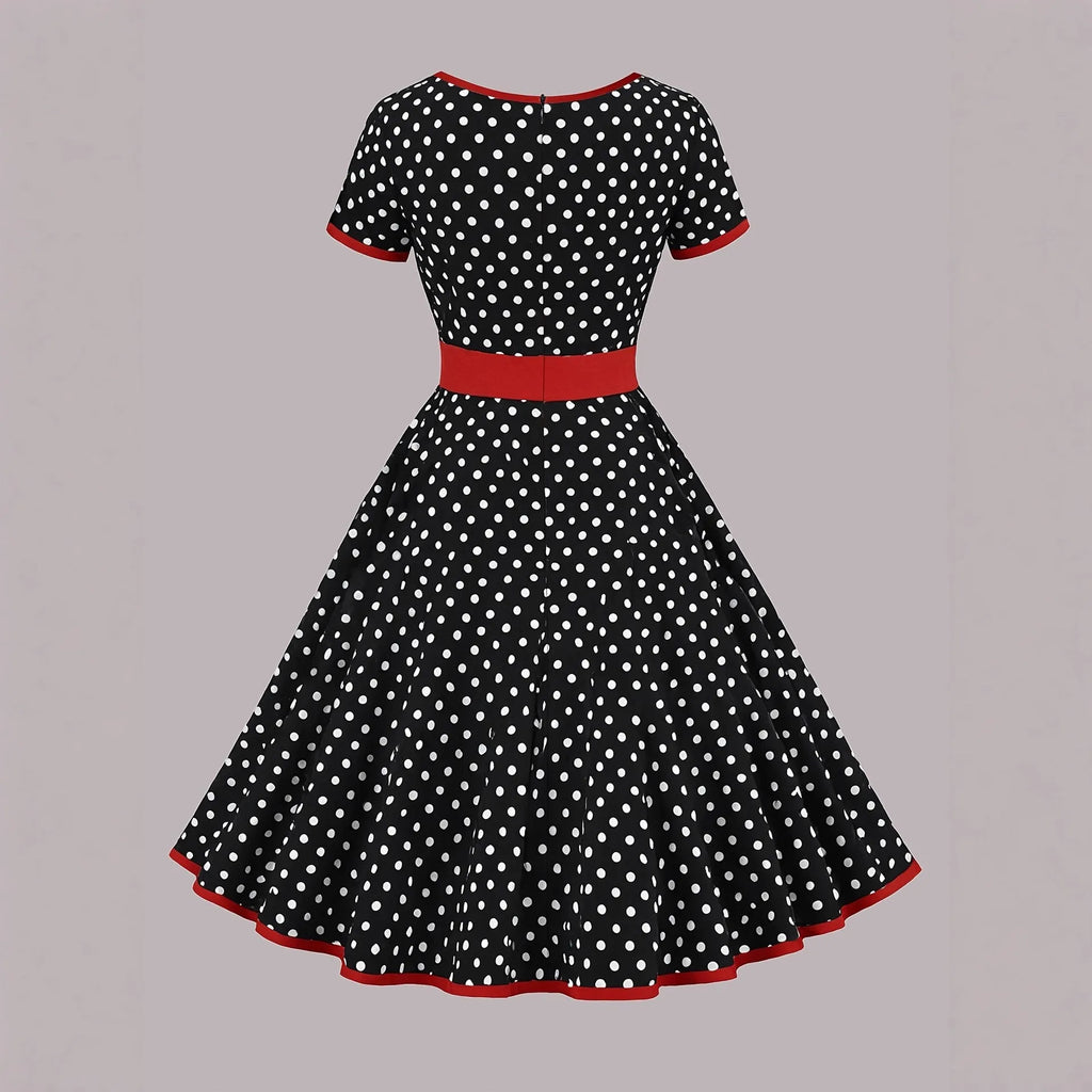 Multicolour polka dot dress with a square neckline, short sleeves, front zipper, and a pleated midi skirt on a hanger.
