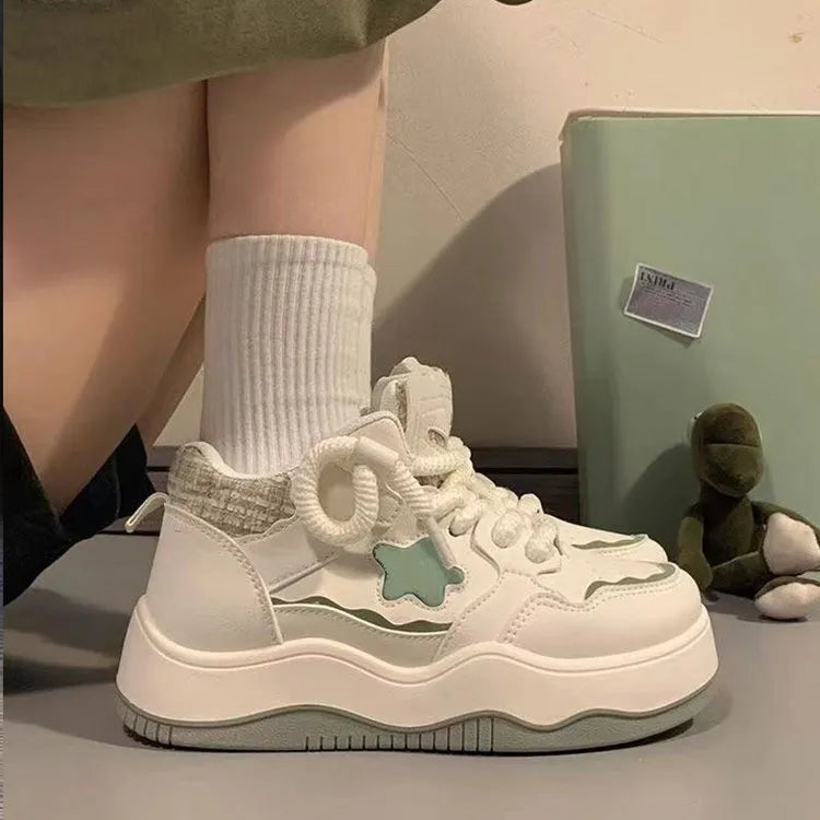 Women's green platform sneakers with round toe and lace-up closure on rubber sole