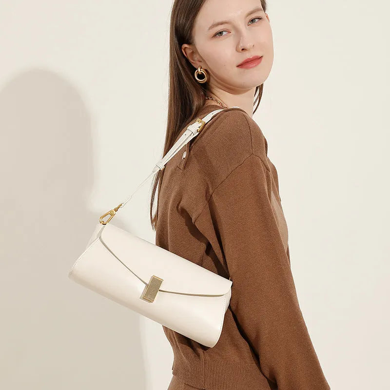 Women's leather cross-body shoulder bag in clamshell design with internal organisers.