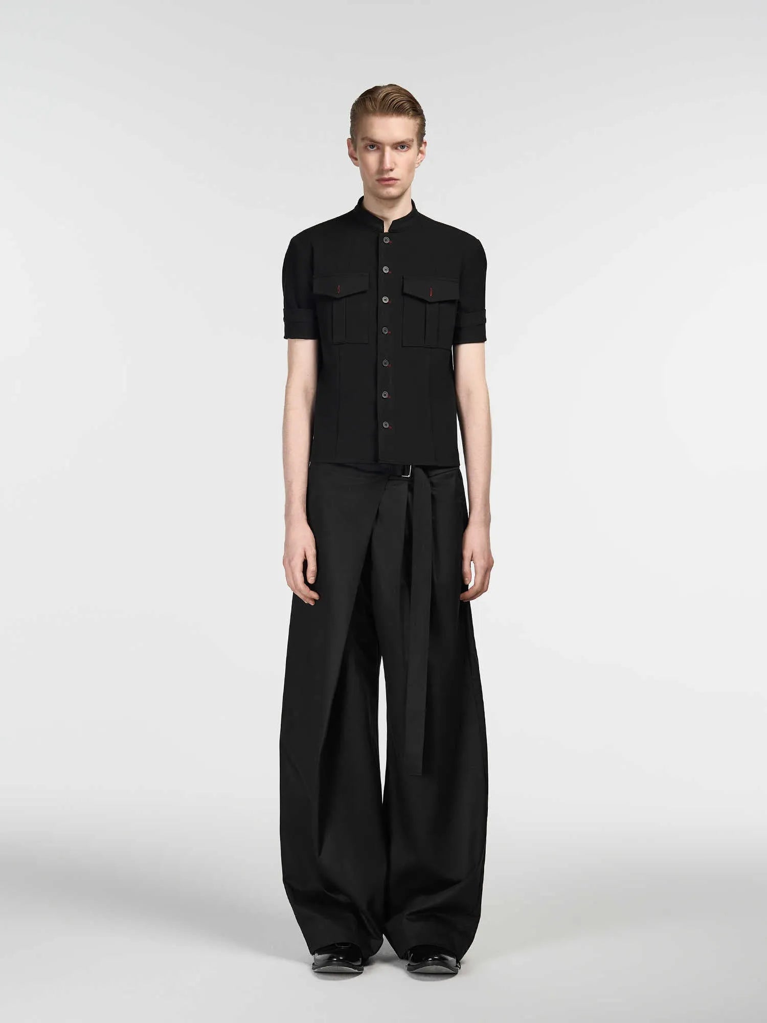 Black straight-leg trousers with a single pleat and adjustable waistband laid flat.