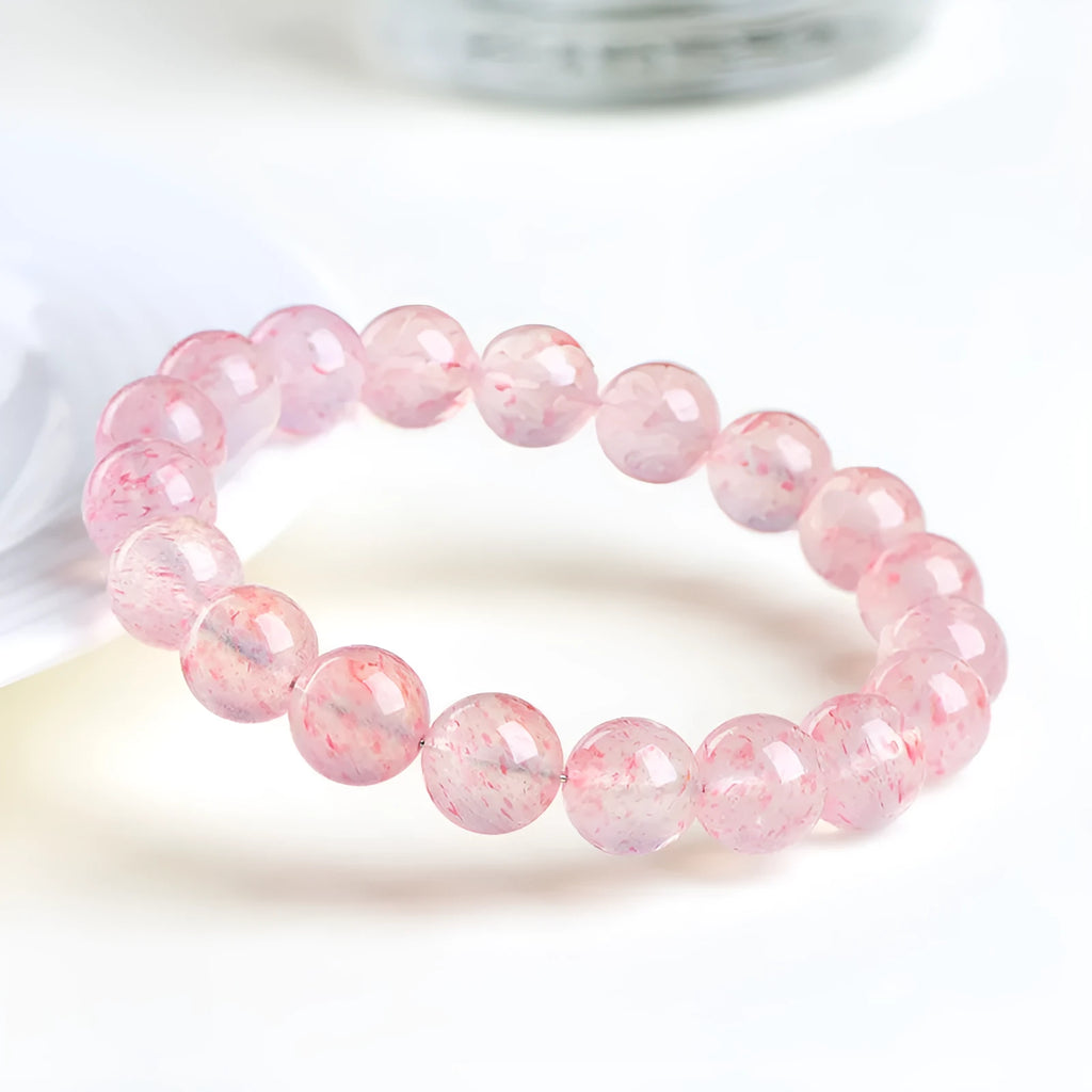 Natural white water strawberry quartz crystal ball bracelet with geometric beads.