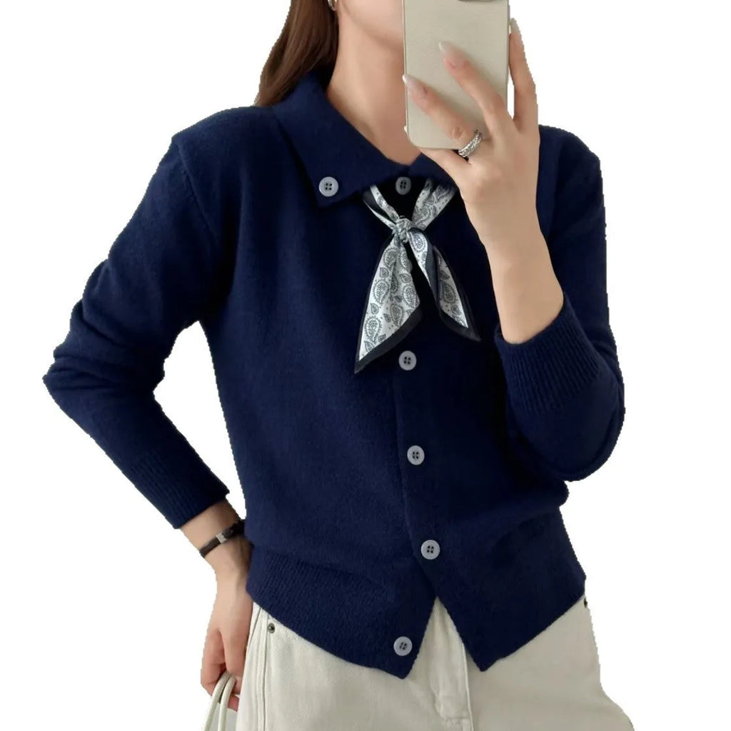 Milky white cardigan sweater with a lapel scarf collar and spliced knit detailing.