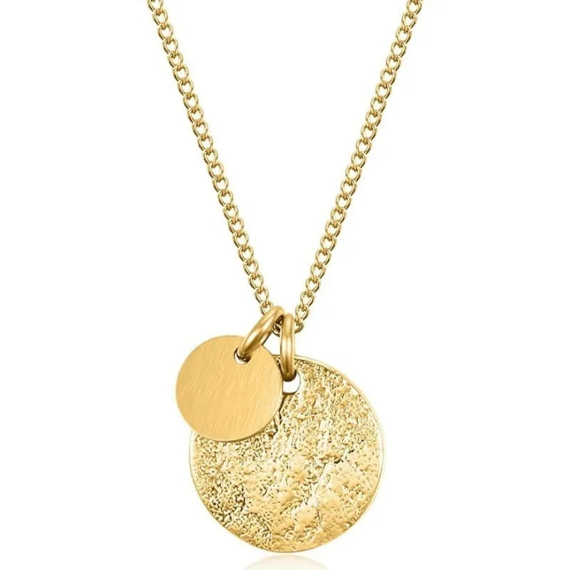 Round coin stainless steel pendant necklace in gold with adjustable side chain on a white background