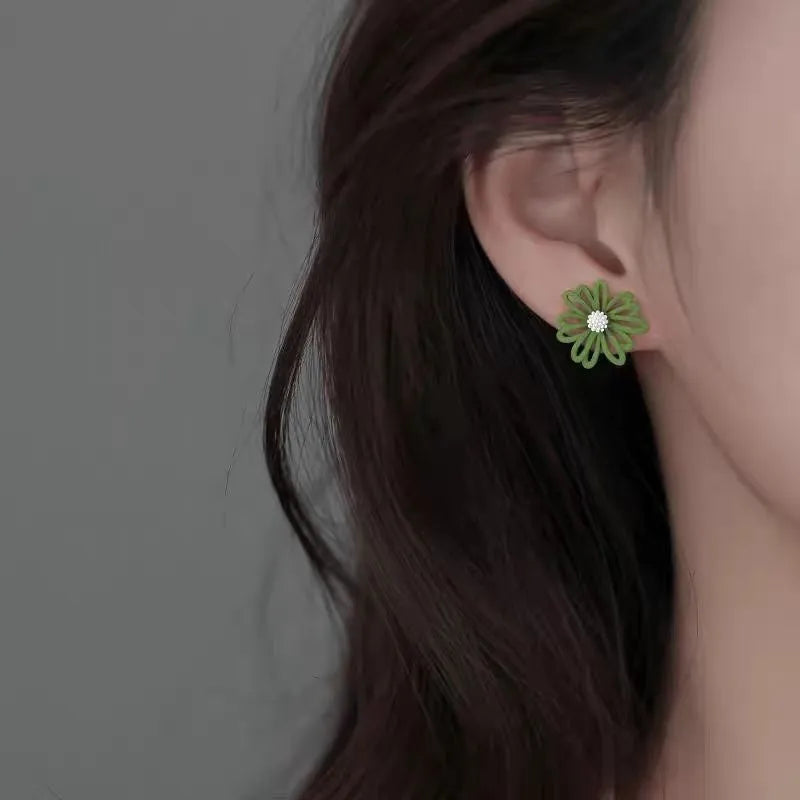 Close-up of colourful cartoon flower stud earrings in alloy on a white background.