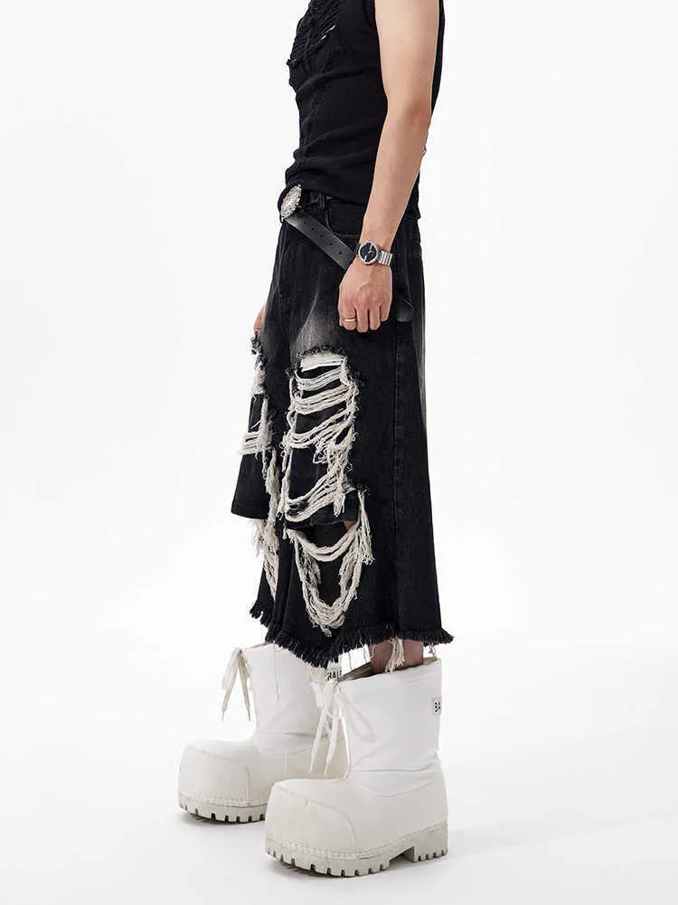 Black wide leg cropped jeans with distressed patch details and a mid-high waist.