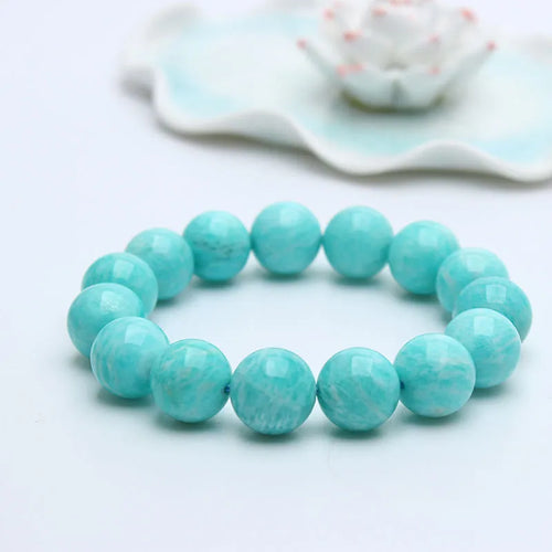 Natural blue-green amazonite bead bracelet with elastic band on a wrist.