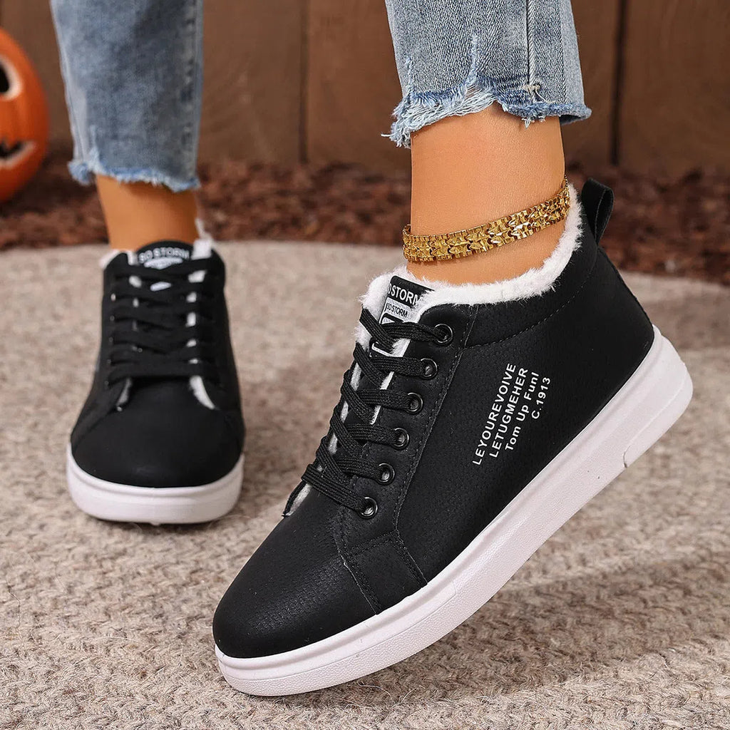 Women's flat sneakers with round toe and front lacing in black, brown, white, and pink