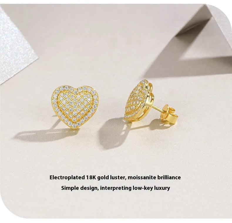 Gold and silver heart-shaped moissanite stud earrings with butterfly clutch fastenings