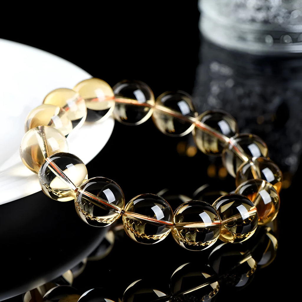 Original design natural citrine scattered bead bracelet on a wrist, showing polished stones in a golden hue.