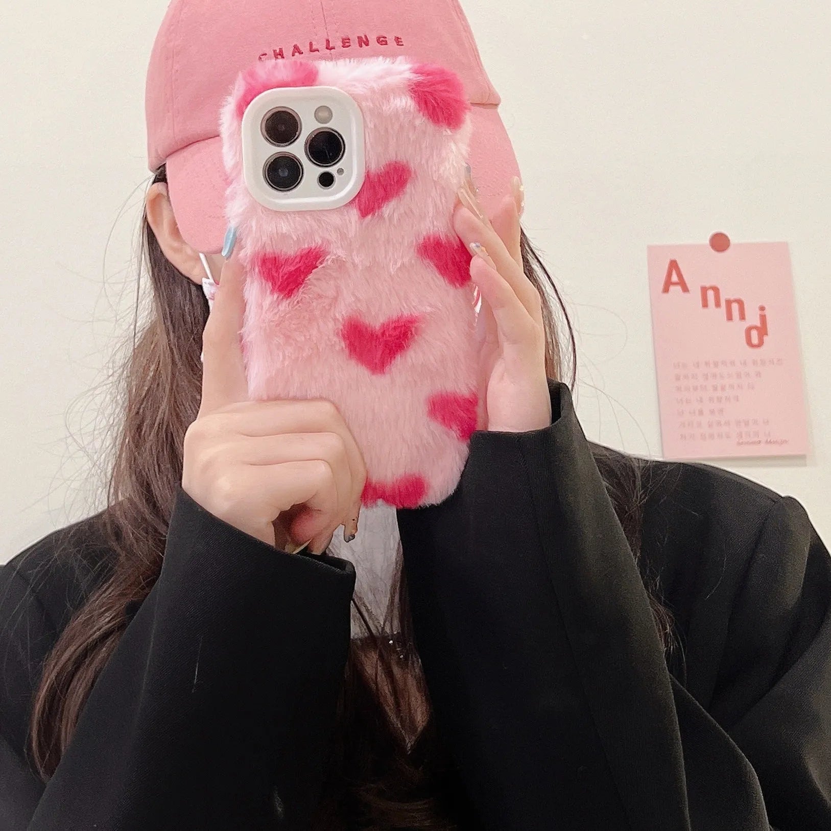 Pink silicone phone case with cartoon design for iPhone models 12, 13, 14, and 15.