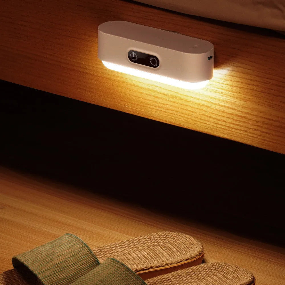 White magnetic USB rechargeable LED night light with touch controls mounted on a metal surface.